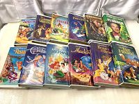 Full view of all 12 Walt Disney VHS tapes showing cases and cover art
