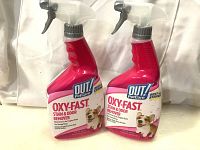 Two red spray bottles labeled Oxy-Fast stain & odor remover surface cleaner for pets, brand OUT! PetCare, 945ml each.
