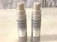 Two bottles of Shiseido White Lucent Total Brightening Serum with front labels showing brand and product name