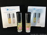 Two 5ml bottles labeled The Organic Pharmacy Protect & Repair Serum Duo with boxes behind them.