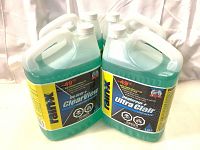 Four full jugs of Rain-X ClearView De-Icer+ windshield washer fluid displayed on a white surface with white backdrop, showing front and side label views.