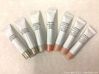 7 tubes of Shiseido skincare arranged on flat surface showing brand and product names