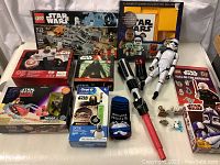 Lot overview showing many Star Wars items including LEGO sets, toothbrush, socks, figurines, and books