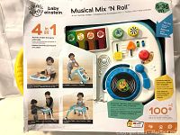 Front packaging showing the 4-in-1 modes, musical instruments, and multilingual support (English/French/Spanish) for ages 6-36 months.