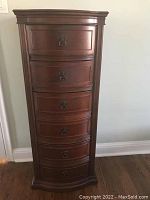Front view of tallboy chest showing bow-front case and six drawers with drop-ring pulls
