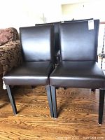 Front view showing two chairs side by side on hardwood floor