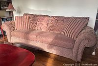 Front view of sofa showing full length, rolled arms and wooden feet