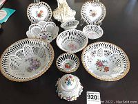 Overall view of the assortment of decorative porcelain bowls and jar, showing designs and lace-like edges