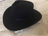 Photo of black felt cowboy hat showing crown and wide brim