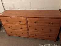 Front view of 6-drawer pine dresser against basement wall