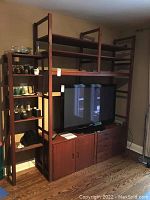 Main IKEA Ivar shelving unit showing TV and shelving above with cabinets and drawers below.