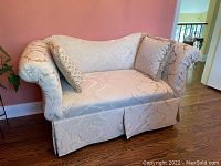 Full view of the custom made loveseat showing the fabric pattern and matching pillows.