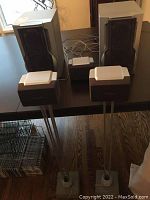 Five Panasonic speakers displayed; two floor-standing and three smaller on stands.