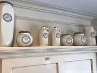 Full set of Clare Wilson kitchen containers displayed on a shelf, showing varieties and labels