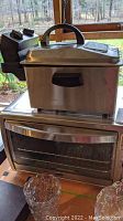 Waring deep fryer and Oster toaster oven stacked, showing overall size and condition