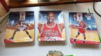 Set of three limited edition Michael Jordan ceramic plates displayed side by side showing basketball action and portrait artwork with Chicago Bulls branding