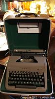 Front view of vintage Royal typewriter in open carrying case showing keyboard and carriage