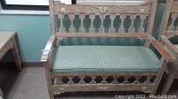 Full view of the Aztec style bench showing wood frame and turquoise vinyl seat cushion.