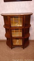Front view of wood storage cabinet with bamboo-front pull out drawers and open side shelves
