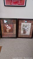 Both floral prints in their frames shown side by side together on floor, visible detail of border and frames