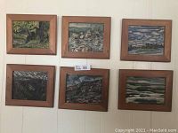 Group photo showing all six framed hand-painted art pieces displayed on a wall, depicting varied natural landscapes.