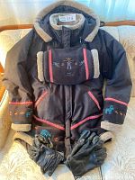 Full display of the black Inuk winter jacket with fleece trim and embroidery, matching hand pouch centered on jacket, black leather gloves below jacket.