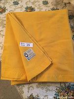 The full folded blanket on a floral tablecloth displaying the color and texture.