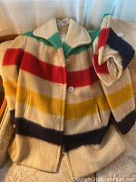 Front view of coat with hood folded at side