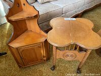 Photo showing both the wooden side table and corner cabinet together on carpet in front of sofa