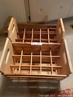 Top-down view showing two wooden wine crates with grid dividers inside, designed to hold 15 bottles each.