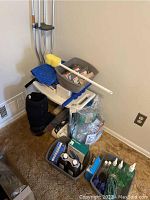 Full view of the lot showing crutches, bath seat, shower chair, grab bar, arm brace, knee immobilizer, and containers with additional supplies