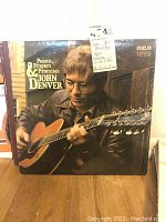 Photo of LP album 'Poems, Prayers & Promises' by John Denver with visible cover art and wear.
