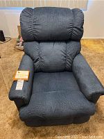Full view of the La-Z-Boy recliner chair showing dark blue textured upholstery and padded cushioning.