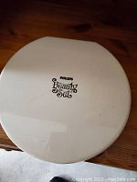 Closed view of white round carrying case with Philips Beauty Set logo on top