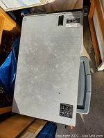 Top view of Dell PowerEdge server showing metal chassis with identification stickers.