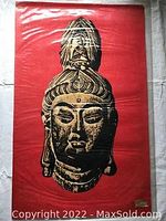 Full view of the batik print fabric showing Guanyin bust in dark colors on red background