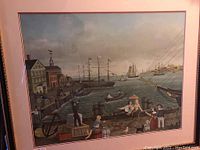 Framed chromolithograph showing a detailed, lively dockside scene with ships and people at the waterfront.