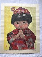 Full view of the woodblock print showing the young child in traditional attire with floral hairpiece on a yellow background.