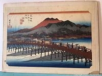 Full view of the Kyoto Sanjo Ohashi print by Hiroshige showing bridge, people, mountain, and water.