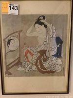 Photo of framed and matted print depicting a woman fixing her hair looking in a mirror in traditional Japanese Ukiyo-e style.