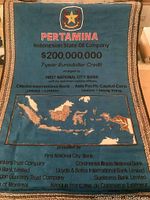 Banner with Pertamina logo and financial credit details in red and black on blue background, map of Indonesia at bottom.