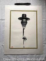 Full view of the print showing an elderly Asian man with a black hat smoking a long pipe, set against a white background with a gold border.