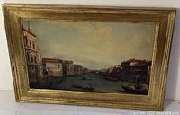 Framed print showing the view of the Grand Canal with gondolas and buildings, with a gold-tone frame.