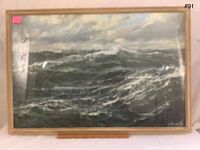 Front view of framed painting depicting rough seas