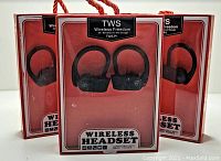 Three boxed new Freedom 45 TWS-P1 wireless headsets with beveled ear hook design shown in packaging. Packages feature red background and display the product name and features clearly, indicating stereo bass and smartphone compatibility.