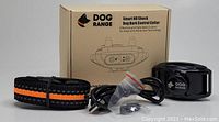 Dog Range Smart NO Shock Dog Bark Control Collar with black and orange nylon collar, USB charging cable, and small plastic accessory displayed in front of the product box.