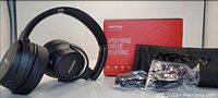 Photo shows MPOW H19ANC wireless headphones in black with soft ear cushions, foldable design, MPOW branded pouch, red MPOW box, and cables.