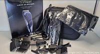 Complete set of Suprent wired professional men's hair clipper and accessories including guide combs, scissors, combs, carrying case, black pouch, and original box