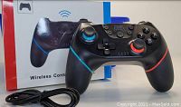 Image of the wireless controller with its box and charging cable displayed in front.