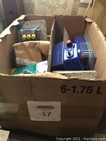Photo of open box containing various aquarium accessories and items including filters and air pumps packed inside.